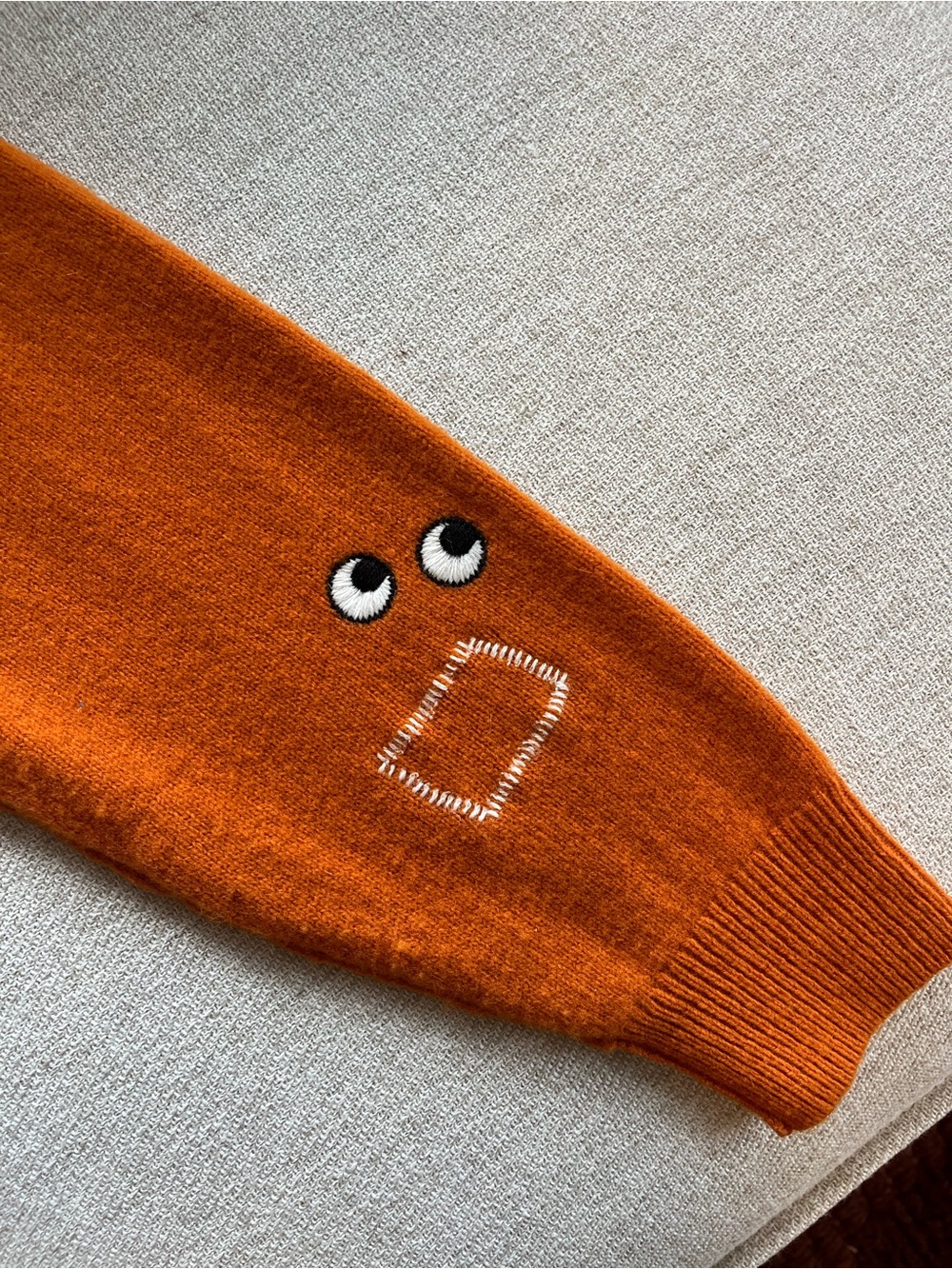 Uniqlo Orange Crewneck Sweater with Eye Patch Embroidery
